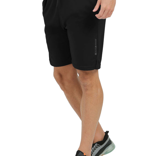 Person wearing black Synco Flare Active shorts on a white background side front