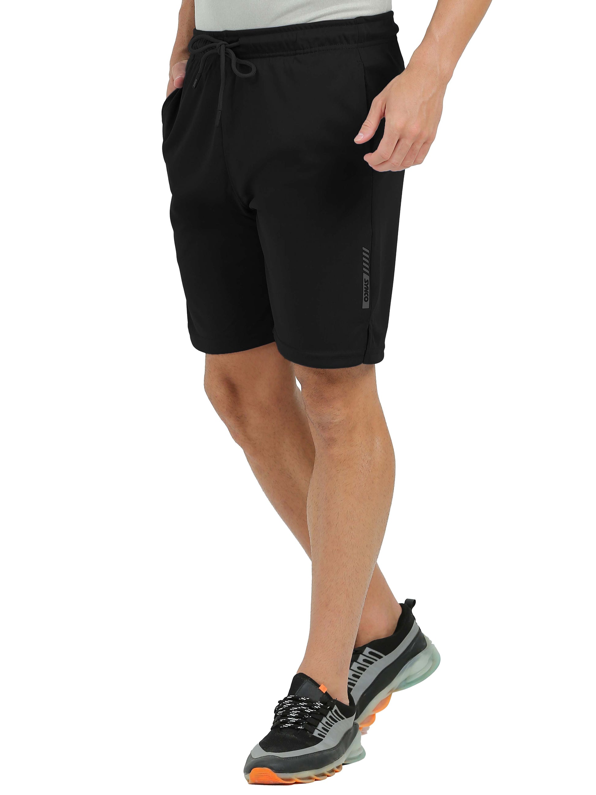Person wearing black Synco Flare Active shorts on a white background side front 